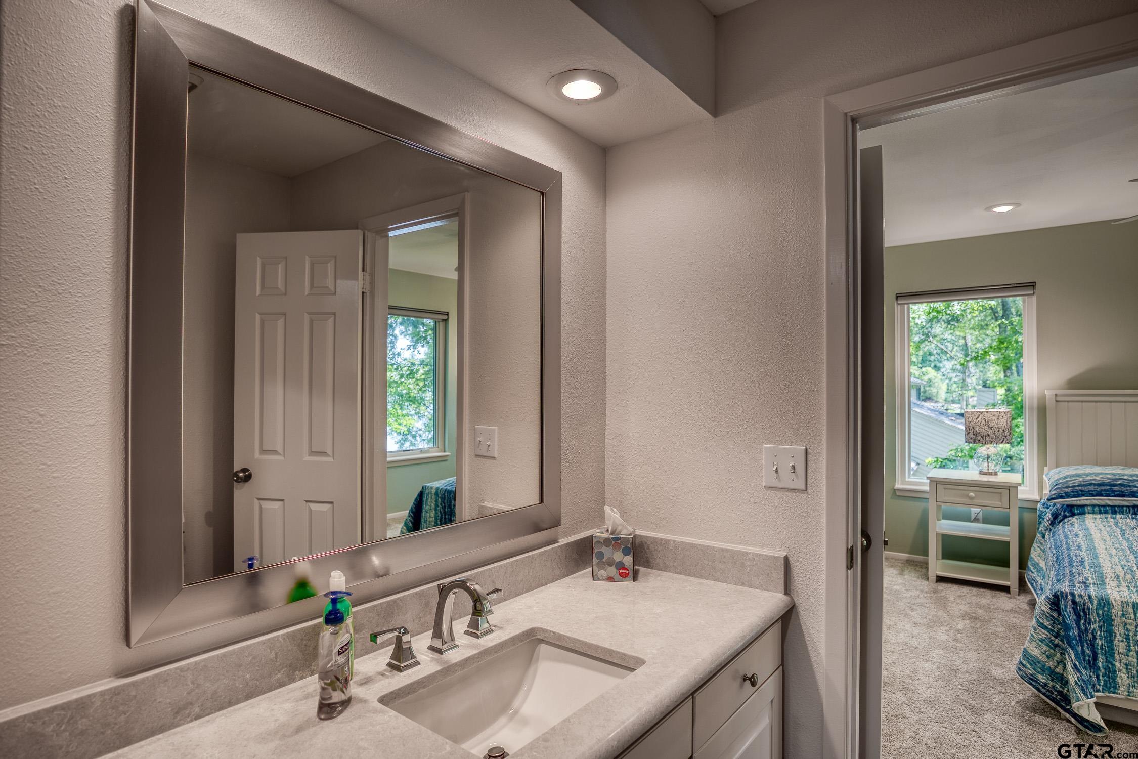 17553 Sleepy Hollow Way Flint, TX 75762 - Photo 26 of 41 a bathroom with a sink and a mirror