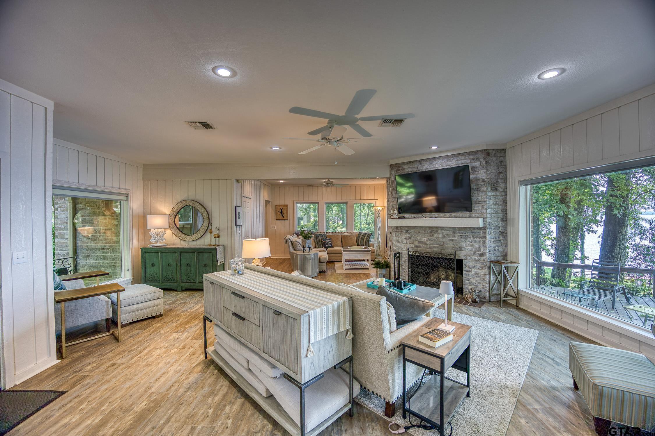 17553 Sleepy Hollow Way Flint, TX 75762 - Photo 6 of 41 a living room with furniture a fireplace and a floor to ceiling window