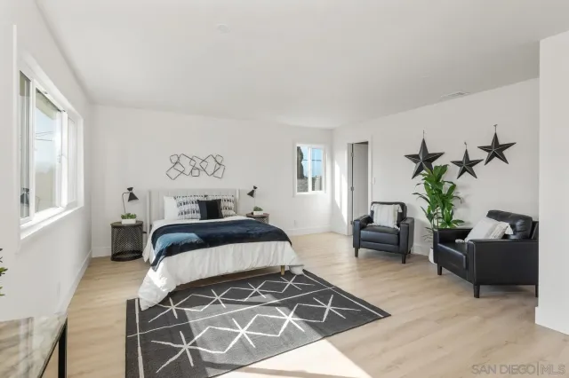 a bedroom with a bed and a couch