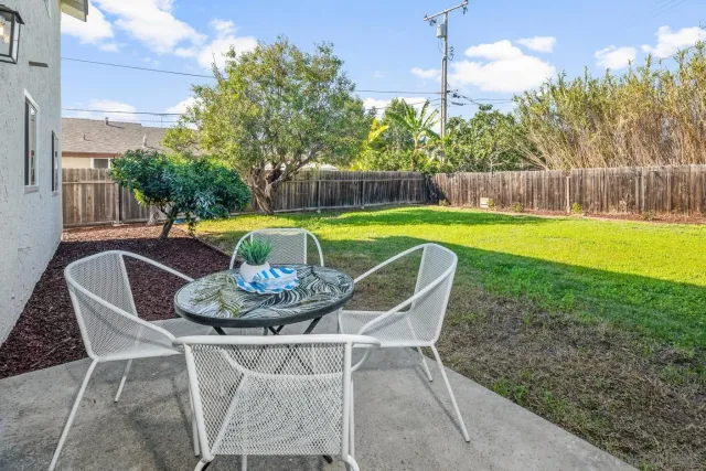 a swimming pool with outdoor seating and yard