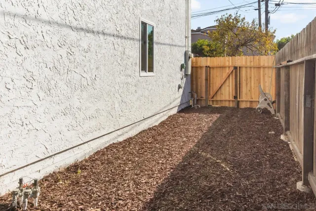 a view of a backyard with wooden fence