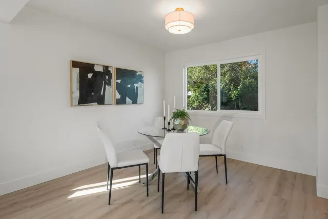 a view of a dining room with furniture window and wooden floor
