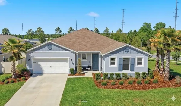 a front view of a house with a garden