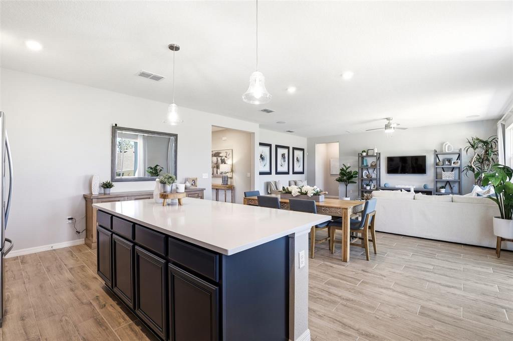 740 Rioja Drive Minneola, FL 34715 - Photo 14 of 33 a large kitchen with a table and chairs
