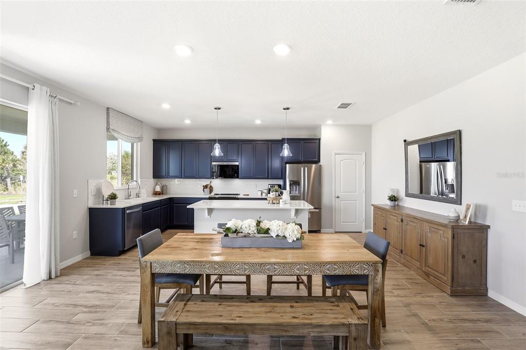 740 Rioja Drive Minneola, FL 34715 - Photo 16 of 33 a large kitchen with a table and chairs