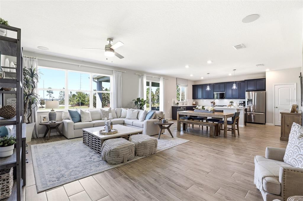 740 Rioja Drive Minneola, FL 34715 - Photo 20 of 33 a living room with lots of furniture and view of kitchen