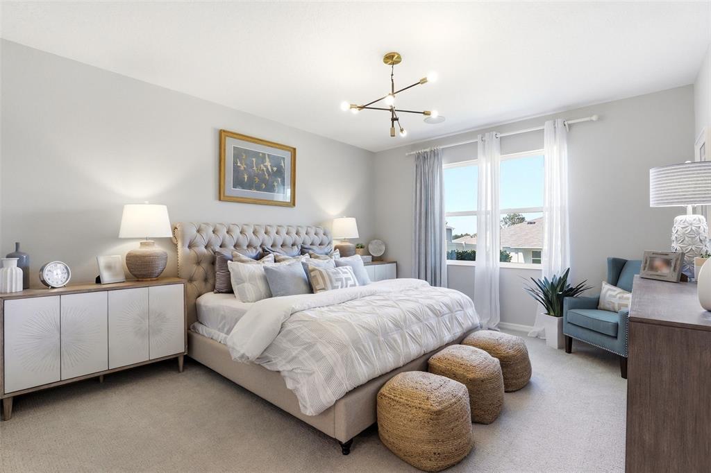 740 Rioja Drive Minneola, FL 34715 - Photo 21 of 33 a bedroom with two beds and painting on the wall