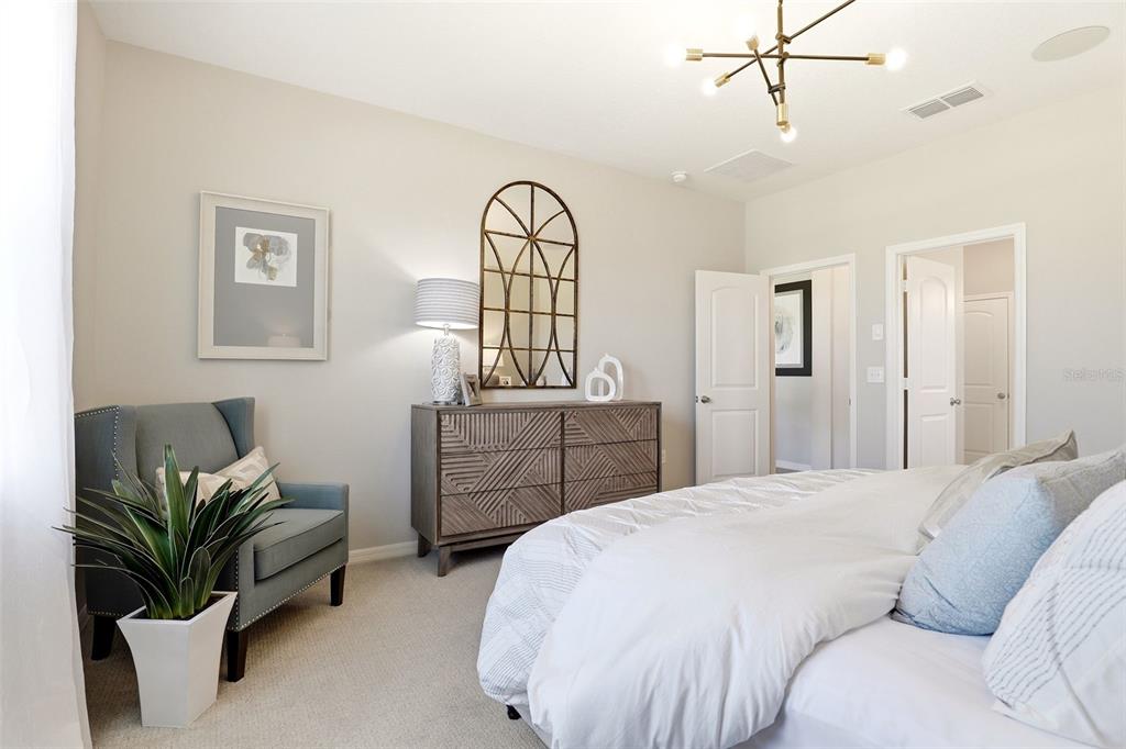 740 Rioja Drive Minneola, FL 34715 - Photo 22 of 33 a bedroom with a bed and furniture