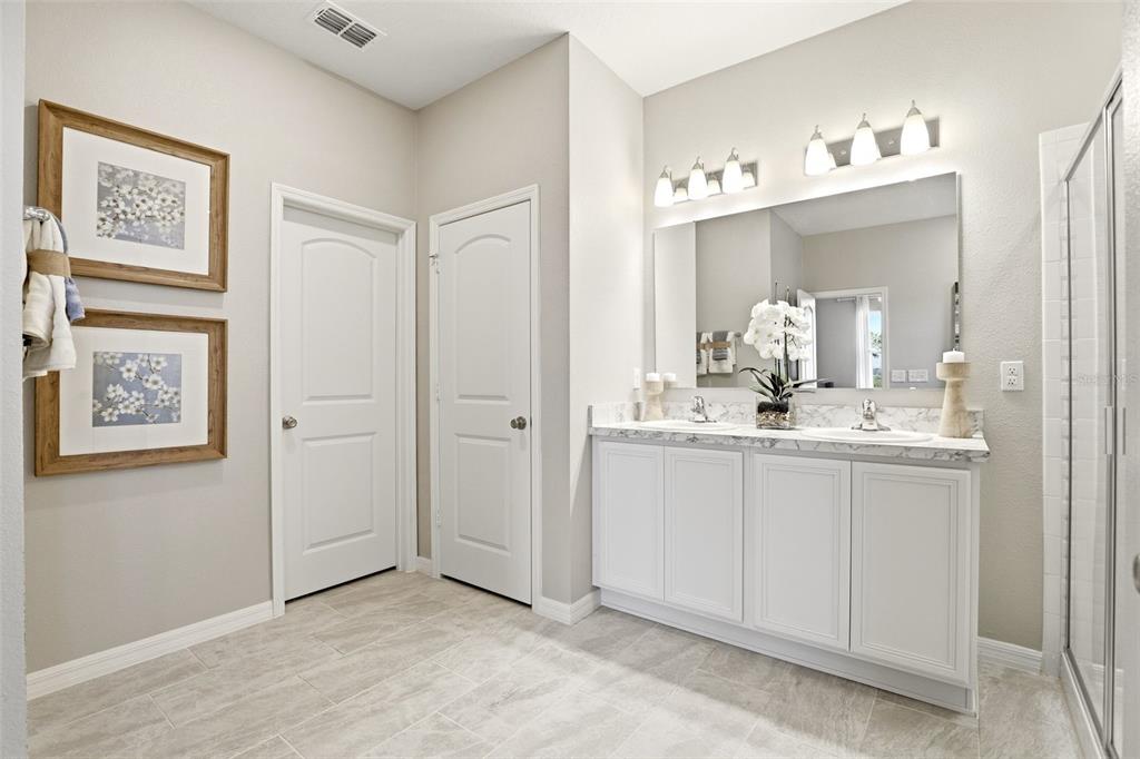 740 Rioja Drive Minneola, FL 34715 - Photo 23 of 33 a spacious bathroom with a mirror sink and vanity