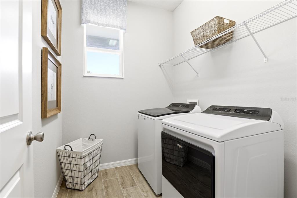 740 Rioja Drive Minneola, FL 34715 - Photo 25 of 33 a utility room with dryer and washer