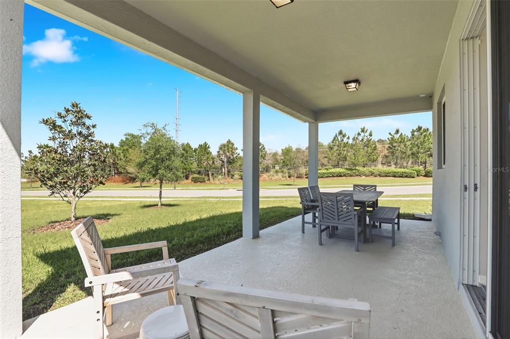 740 Rioja Drive Minneola, FL 34715 - Photo 26 of 33 a view of a patio with chairs and backyard