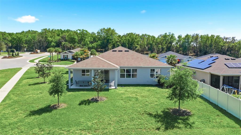 740 Rioja Drive Minneola, FL 34715 - Photo 27 of 33 a backyard of a house with table and chairs