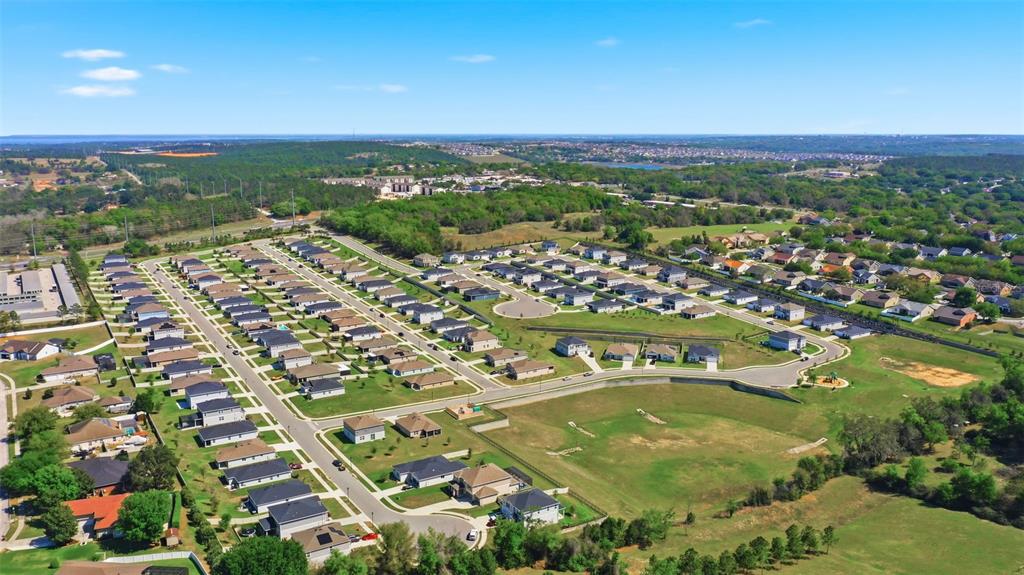 740 Rioja Drive Minneola, FL 34715 - Photo 31 of 33 an aerial view of residential houses with outdoor space and trees