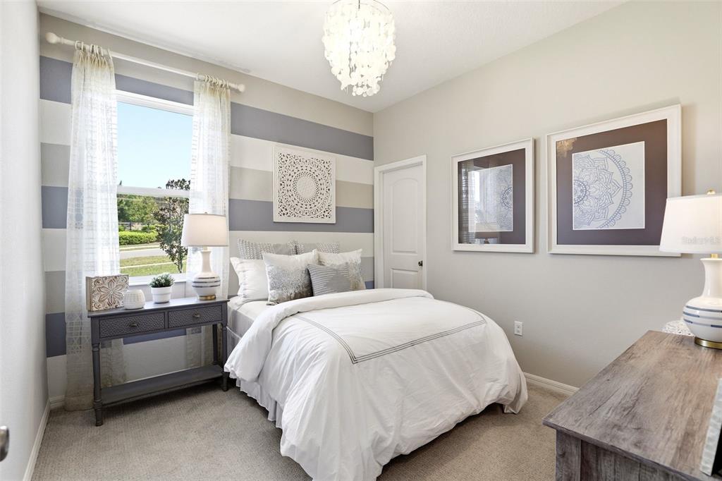 740 Rioja Drive Minneola, FL 34715 - Photo 7 of 33 a bedroom with a bed and a window