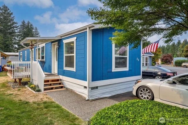 a view of a house with a small yard and wooden fence