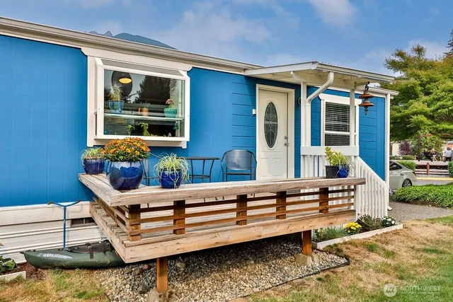 a view of a house with a wooden deck