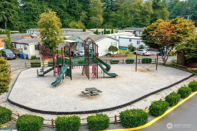 an aerial view of a house with outdoor seating