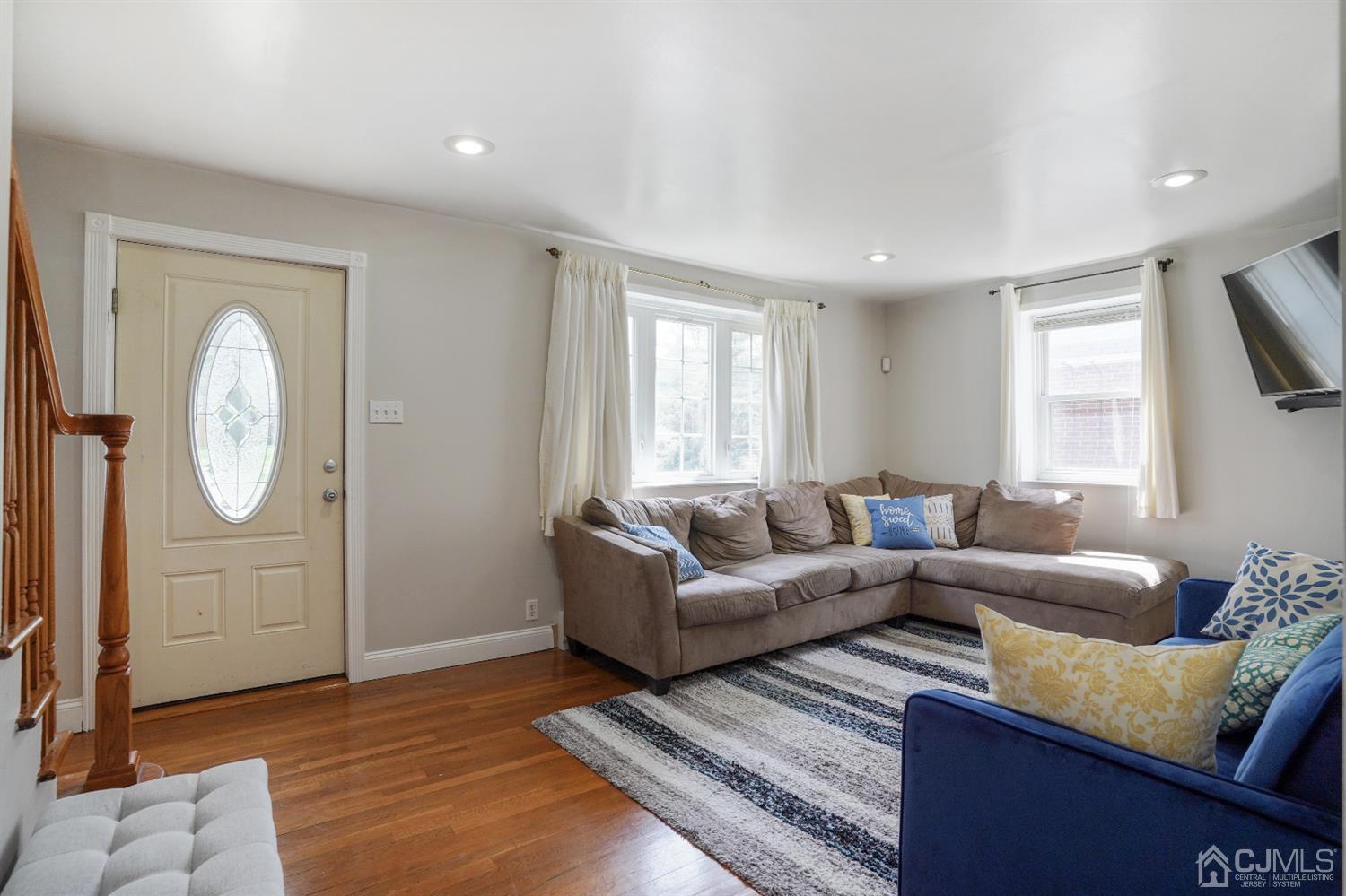 62 Oxford Road Colonia, NJ 07067 - Photo 2 of 10 a living room with furniture a window and a fireplace