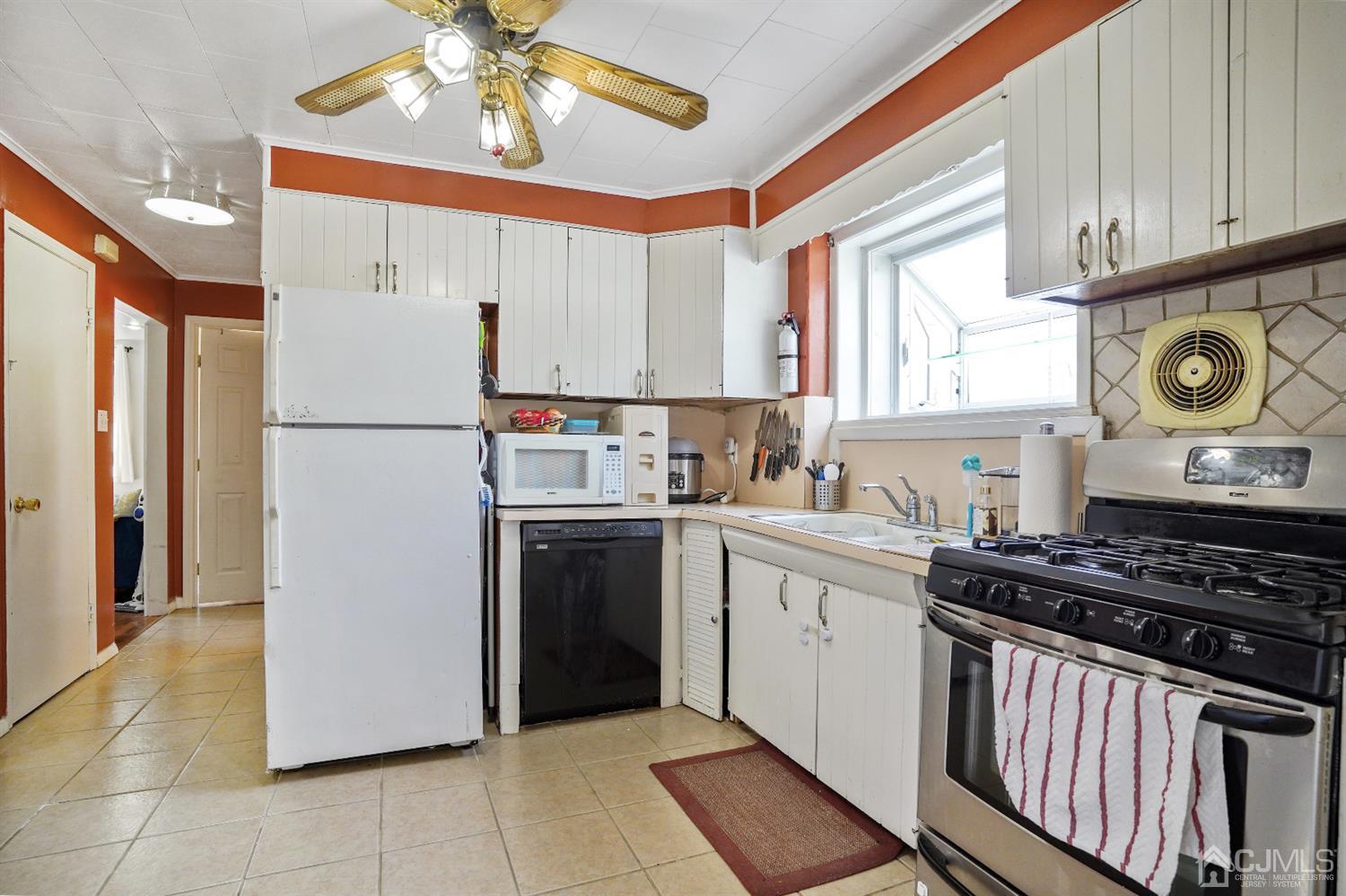 62 Oxford Road Colonia, NJ 07067 - Photo 3 of 10 a kitchen with a stove a refrigerator and a sink