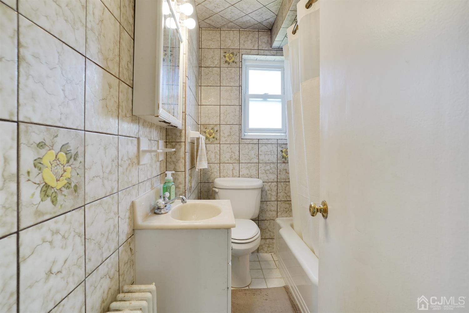 62 Oxford Road Colonia, NJ 07067 - Photo 5 of 10 a bathroom with a sink a toilet and shower