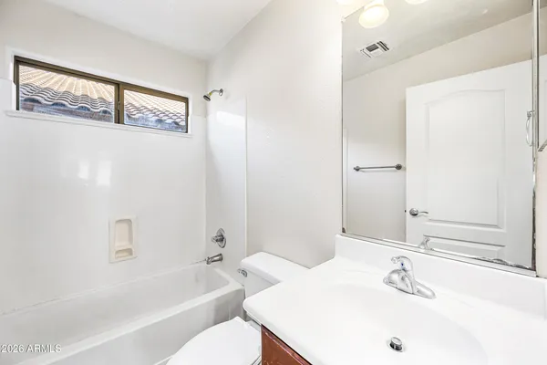 a bathroom with a bathtub shower sink and toilet