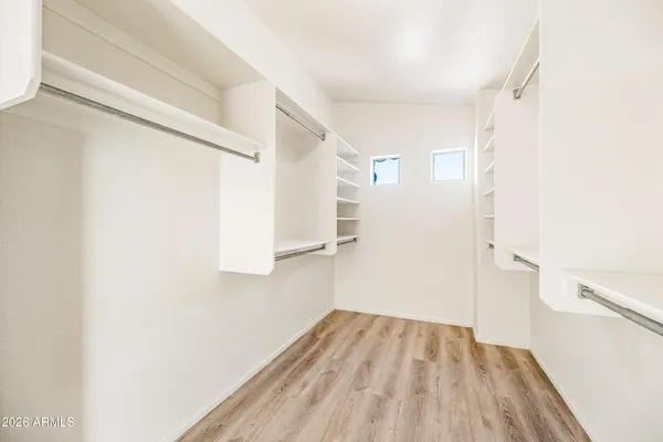 a view of a room with wooden floor and white walls