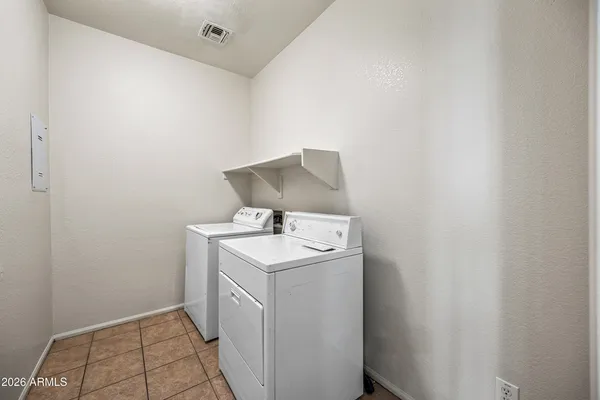 a utility room with sink dryer and washer