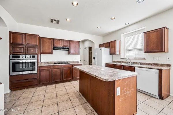 a kitchen with stainless steel appliances granite countertop a stove sink and cabinets