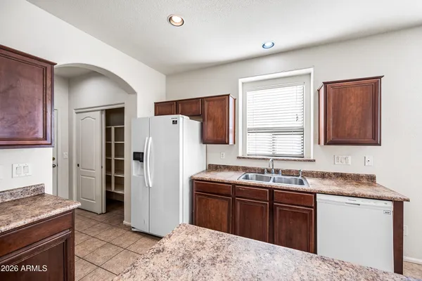 a kitchen with a refrigerator stove top oven and sink