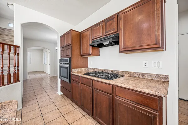 a kitchen with a stove and a refrigerator