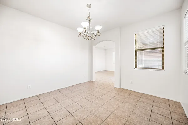 a view of a chandelier fan and entryway