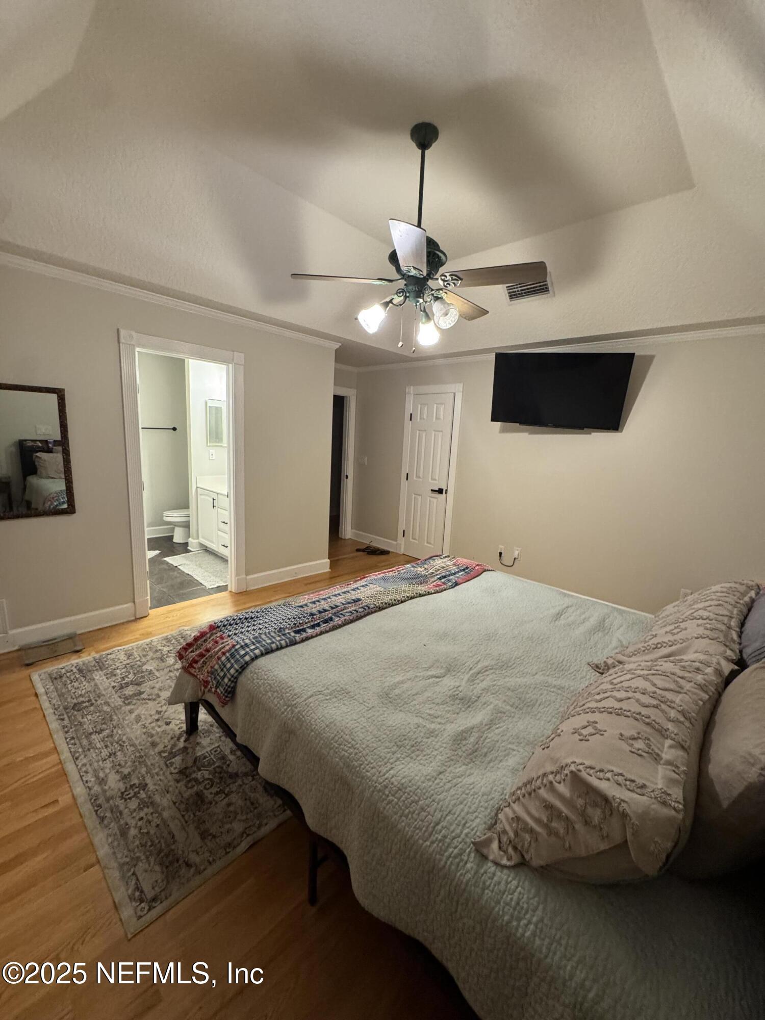 371447 Kings Ferry Road Hilliard, FL 32046 - Photo 55 of 77 a bedroom with a bed window and a chandelier