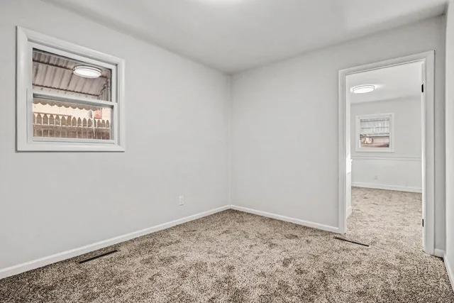 a white house with a large tree in front of it