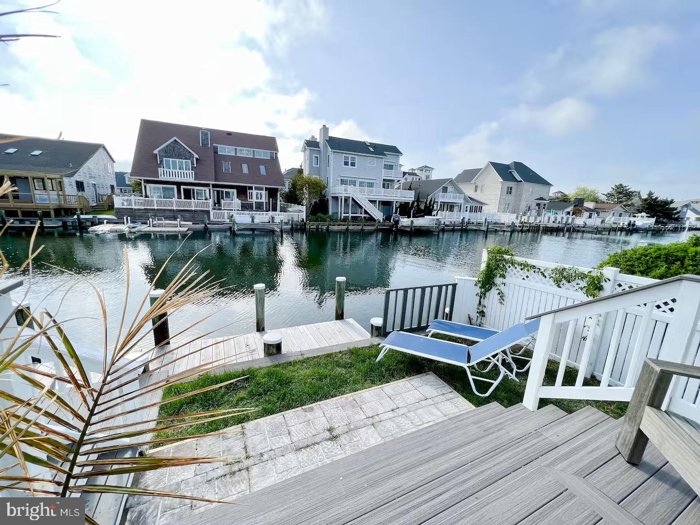 10609 Pine Needle Road Ocean City, MD 21842 - Photo 17 of 26 a view of a lake with a table and chairs