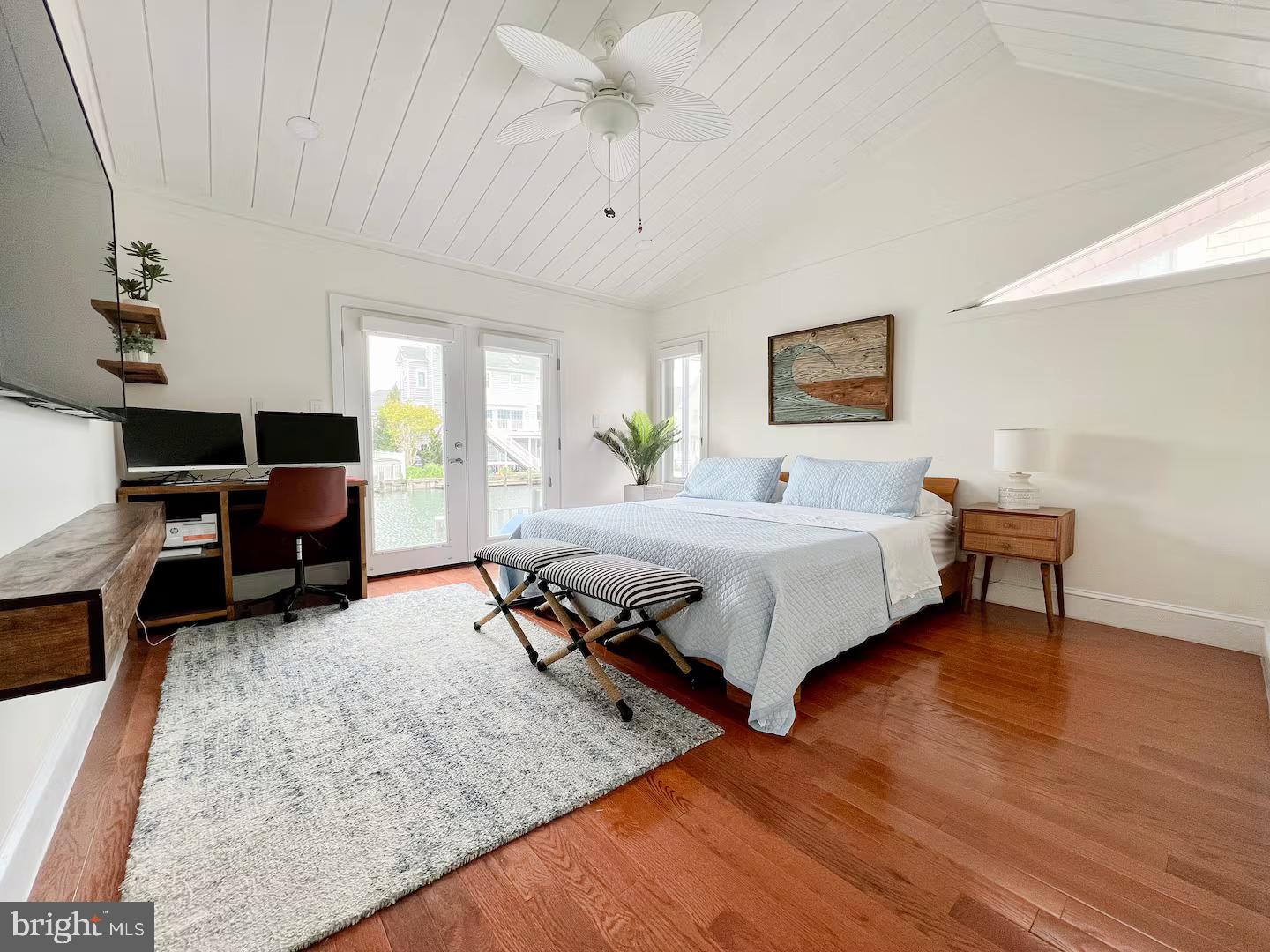 10609 Pine Needle Road Ocean City, MD 21842 - Photo 20 of 26 a bedroom with a bed a couch and a chandelier