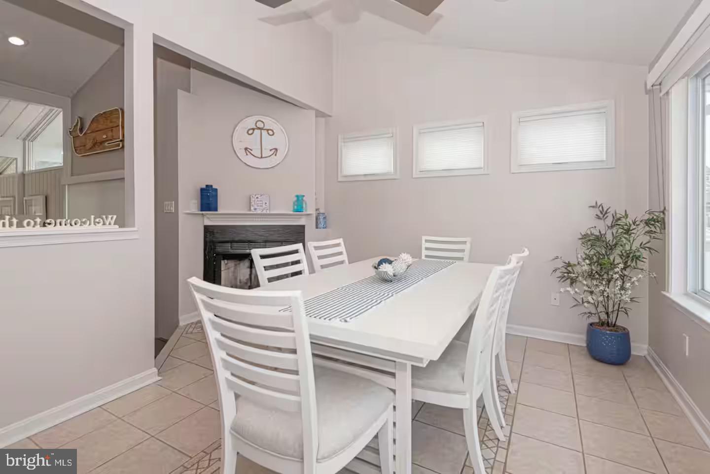 10609 Pine Needle Road Ocean City, MD 21842 - Photo 3 of 26 a view of a dining room with furniture and a potted plant