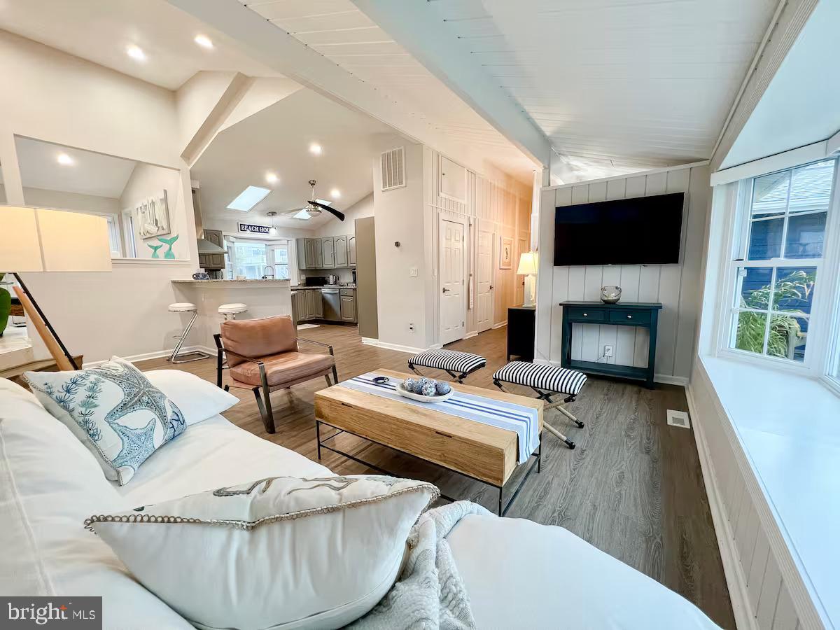 10609 Pine Needle Road Ocean City, MD 21842 - Photo 7 of 26 a living room with couches a flat screen tv and a fireplace