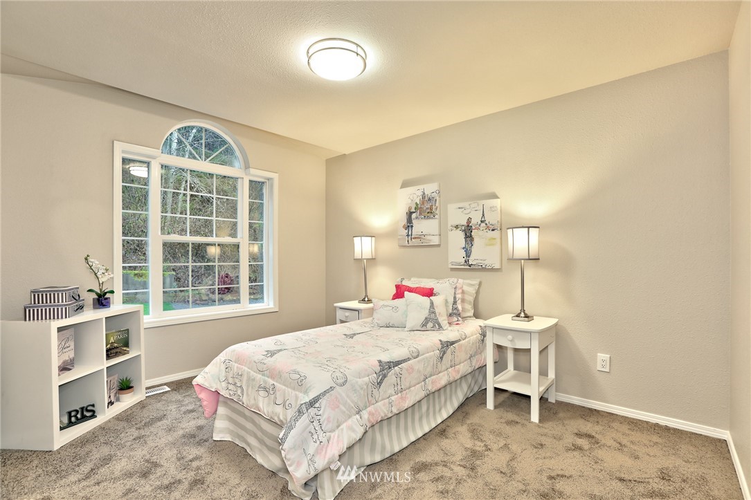 2926 Southwest Lake Roesiger Road Snohomish, WA 98290 - Photo 14 of 27 a bedroom with a bed and a window
