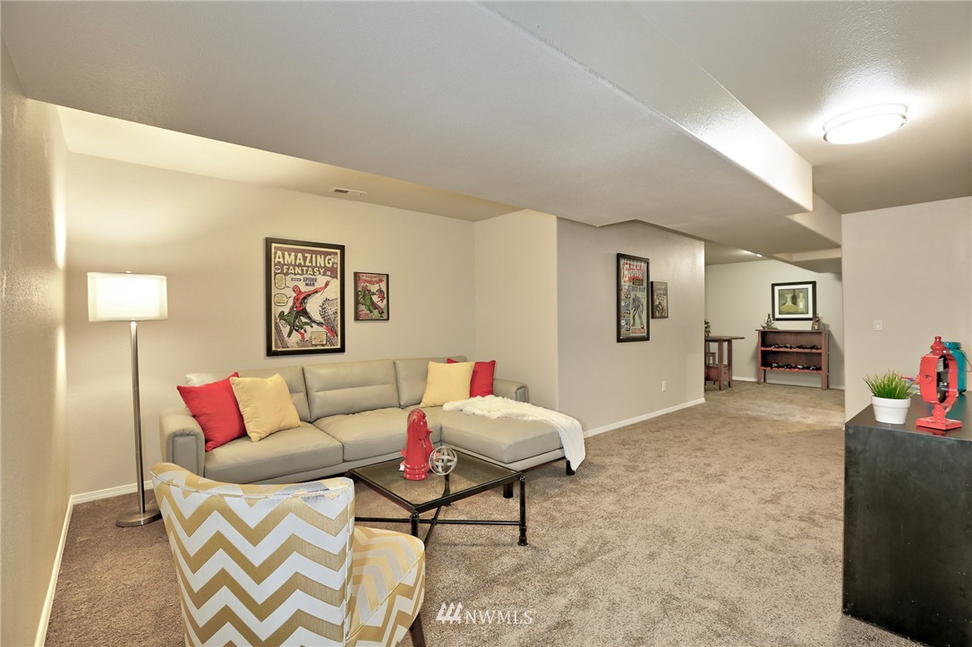 2926 Southwest Lake Roesiger Road Snohomish, WA 98290 - Photo 22 of 27 a living room with furniture and a dining table