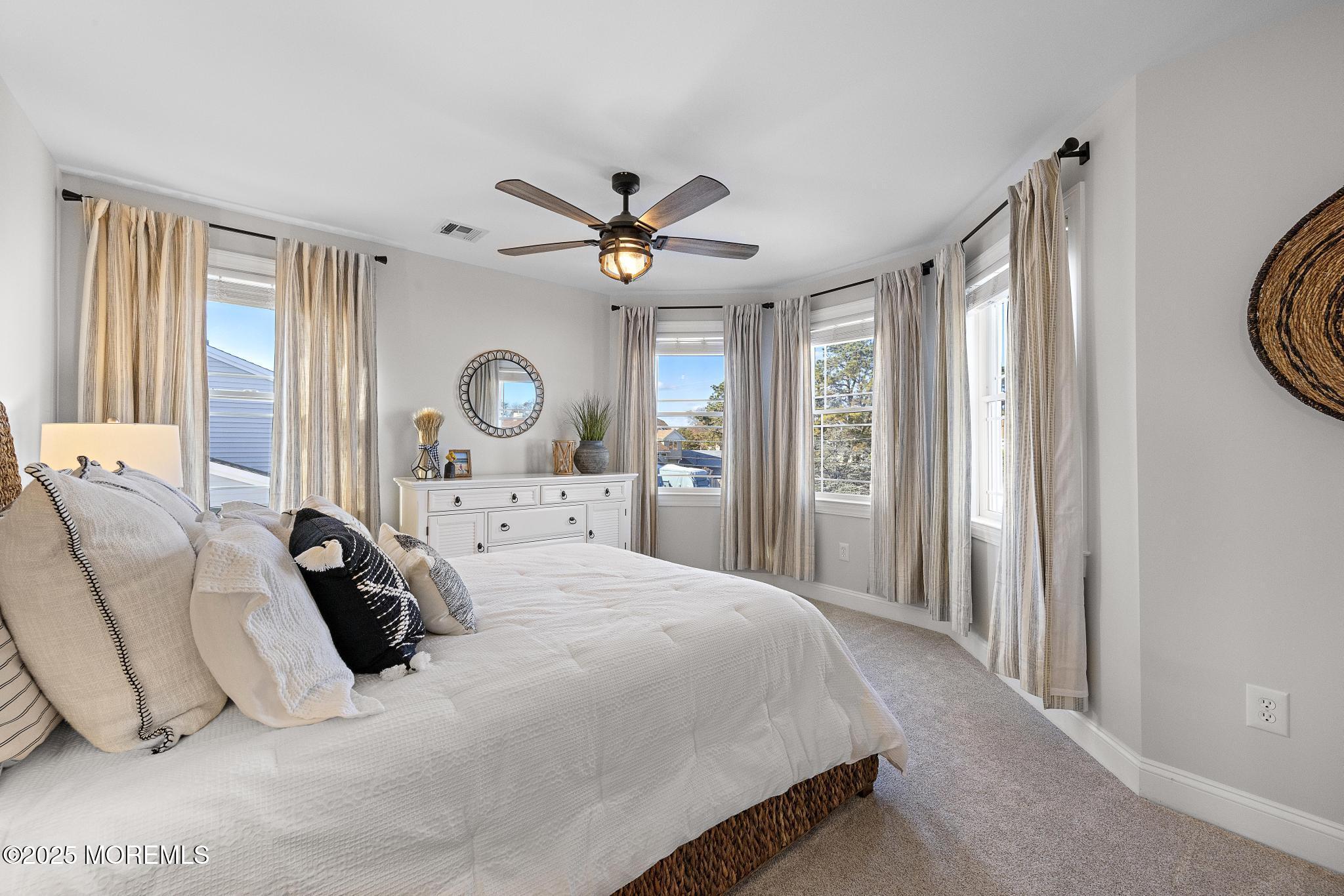 55 Bay Way Brick, NJ 08723 - Photo 18 of 29 a bedroom with a bed large window and a chandelier