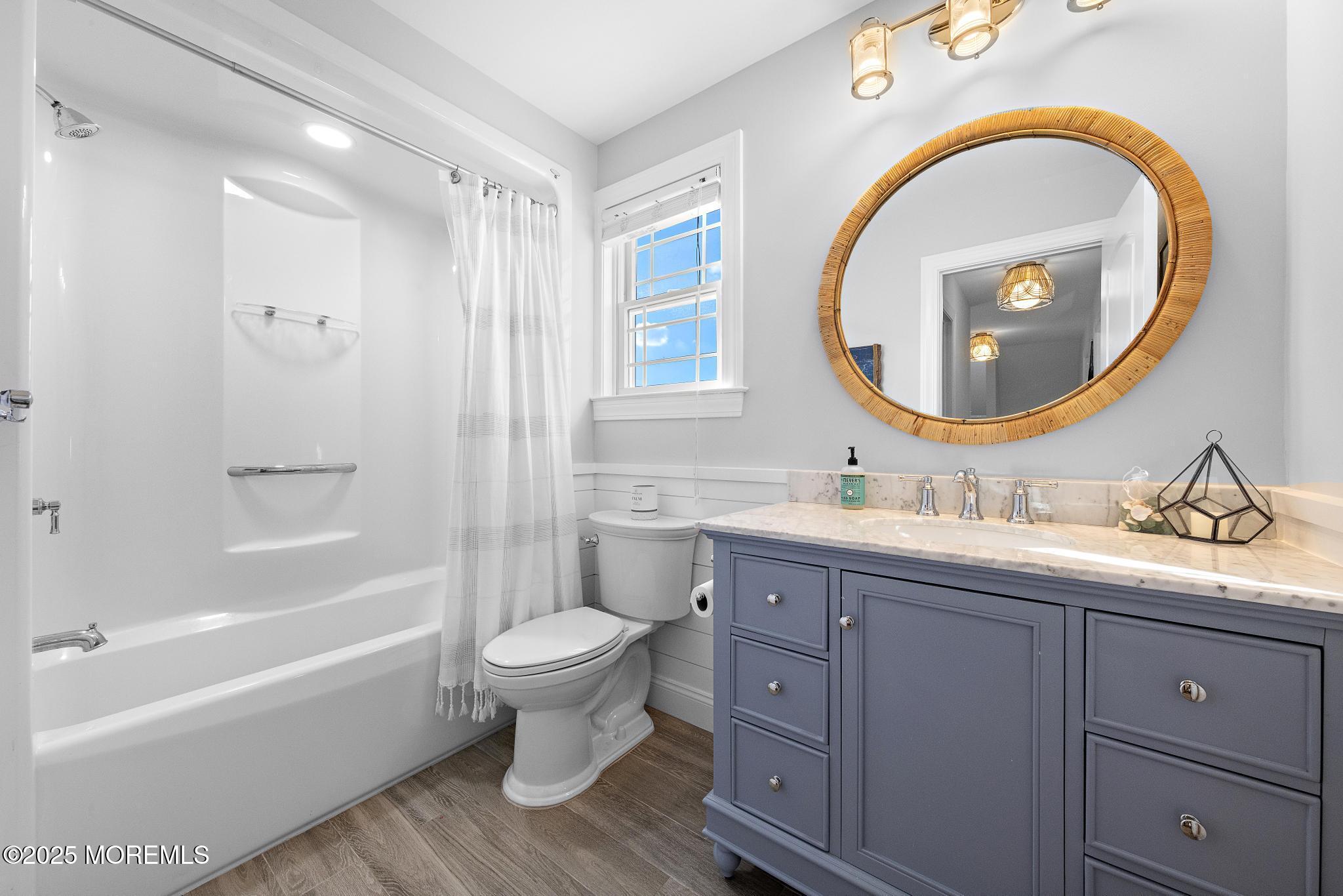 55 Bay Way Brick, NJ 08723 - Photo 19 of 29 a bathroom with a toilet a sink a mirror and bathtub