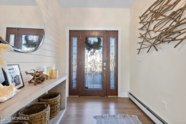 a view of room with furniture and wooden floor