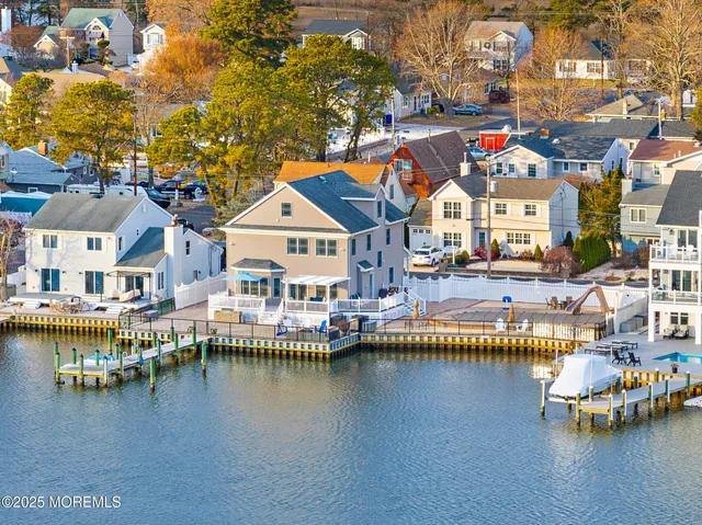 a aerial view of residential houses with outdoor space and lake view