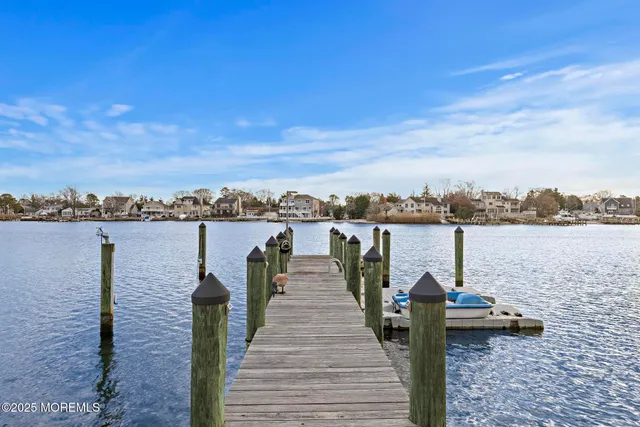 a lake view with a bench next to a yard