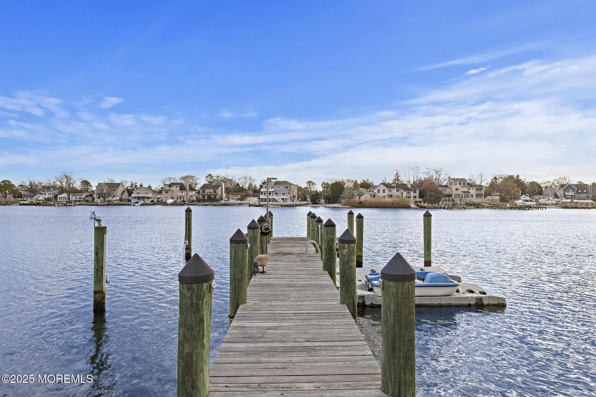 55 Bay Way Brick, NJ 08723 - Photo 28 of 29 a lake view with a bench next to a yard