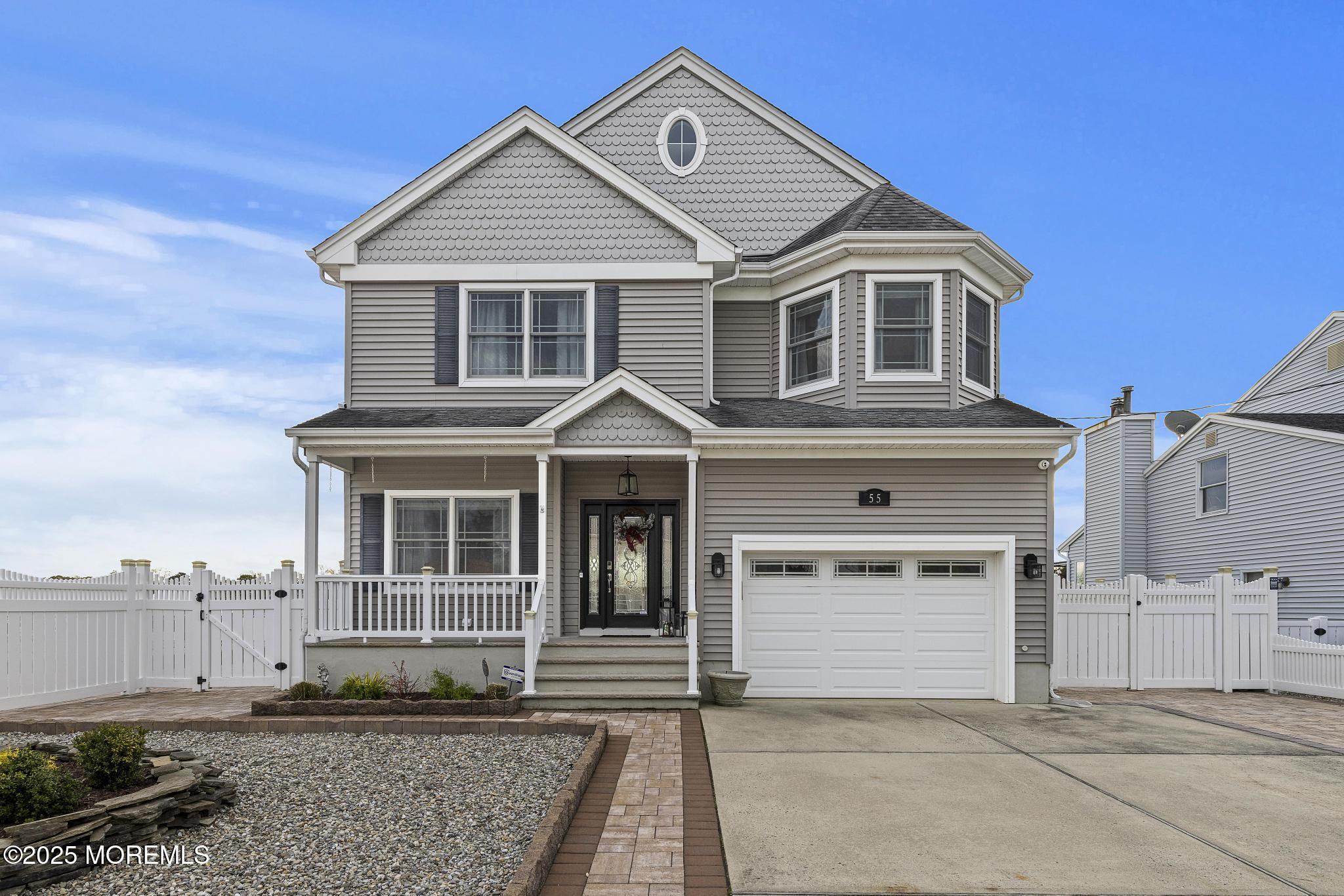 55 Bay Way Brick, NJ 08723 - Photo 29 of 29 a view of a white house with large windows and a yard