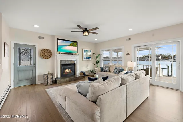a living room with furniture a fireplace and a flat screen tv