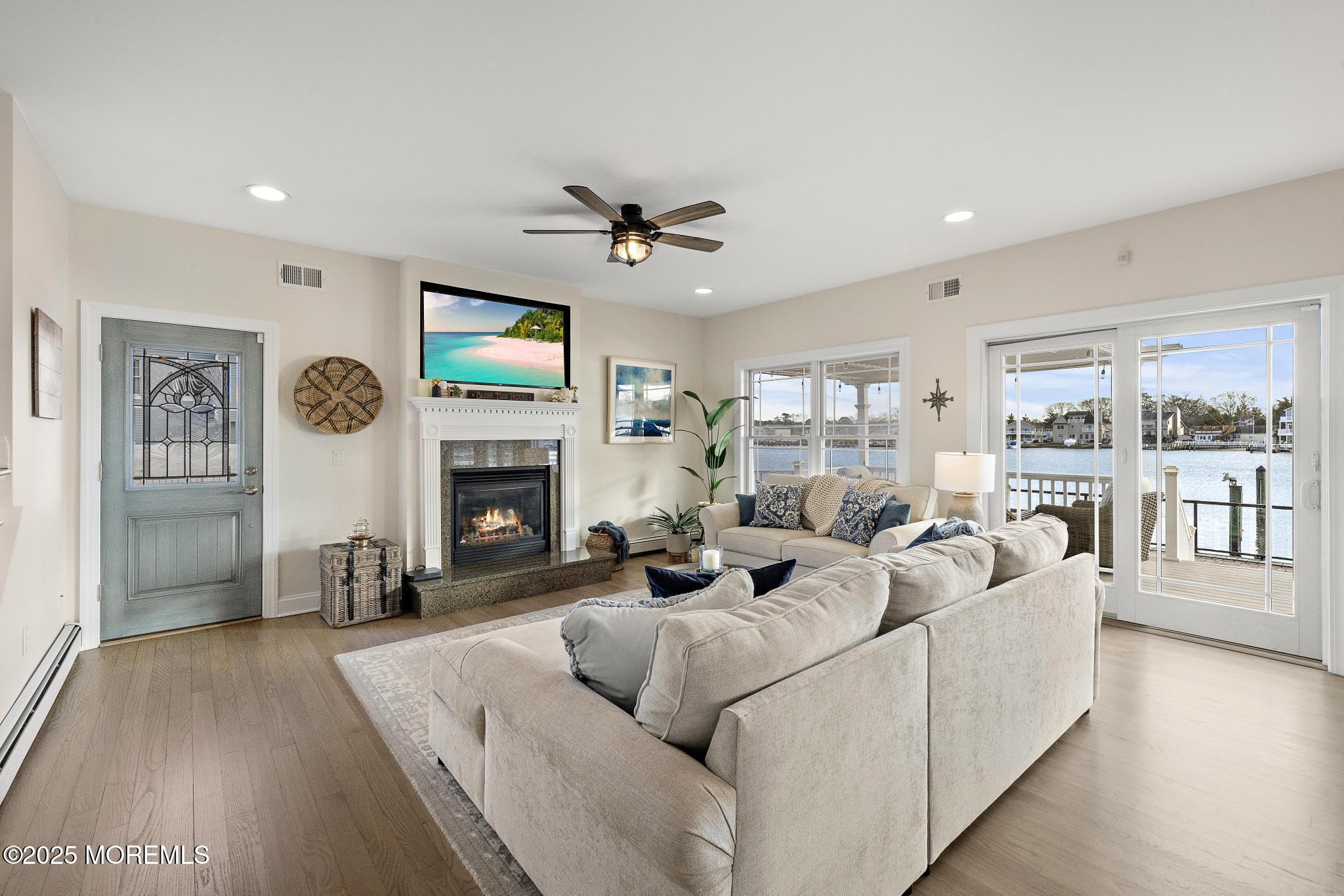 55 Bay Way Brick, NJ 08723 - Photo 5 of 29 a living room with furniture a fireplace and a flat screen tv