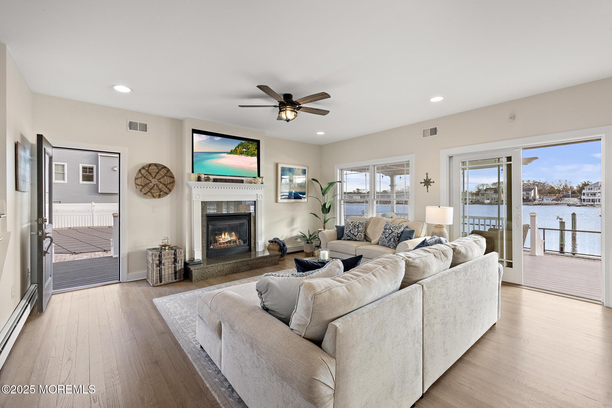 55 Bay Way Brick, NJ 08723 - Photo 6 of 29 a living room with furniture a fireplace and a flat screen tv