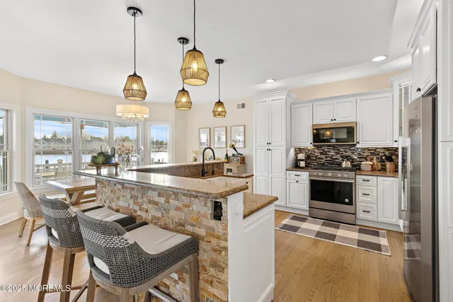 a large kitchen with a table and chairs